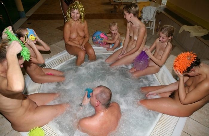 Nudists rest in a big company photo